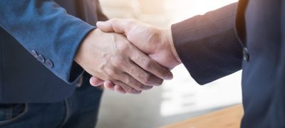 Two confident business man shaking hands during a meeting in the Two confident business man shaking hands during a meeting in the office, success, dealing, greeting and partner concept